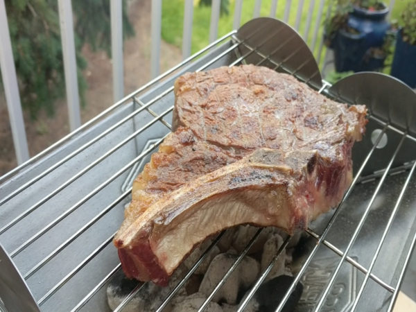 Steak cooking on the UCO Flat Pack Grill 