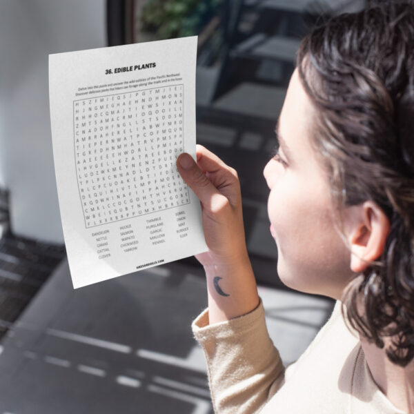 Child enjoying outdoor word search puzzle on camping trip